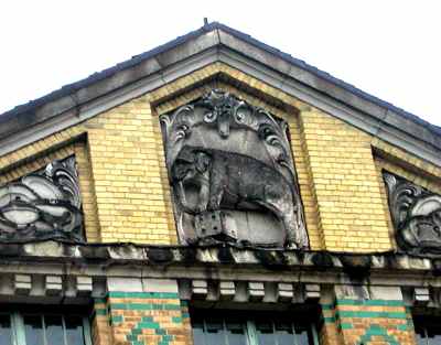 The bas-relief of the elephant stepping on the dice on the pediment of corner building of Aue Metal Goods Factory The bas-relief of the elephant stepping on the dice on the pediment of corner building of Aue Metal Goods Factory