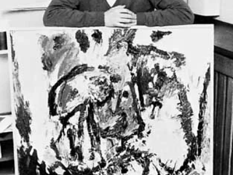 portrait photo of Asger Jorn with a painting