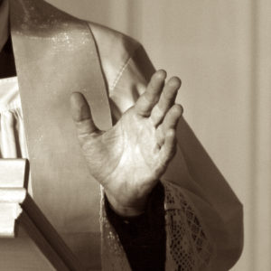 A hand of a preaching priest